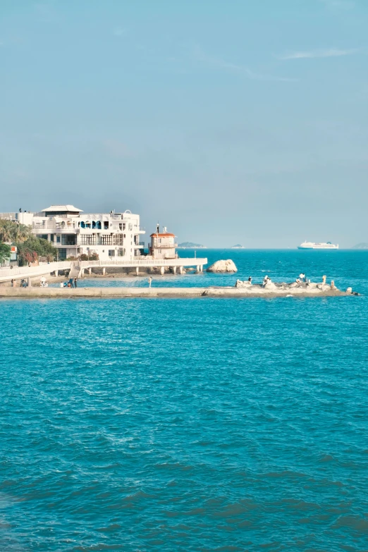 houses on an island, along with boats, sit off the coast