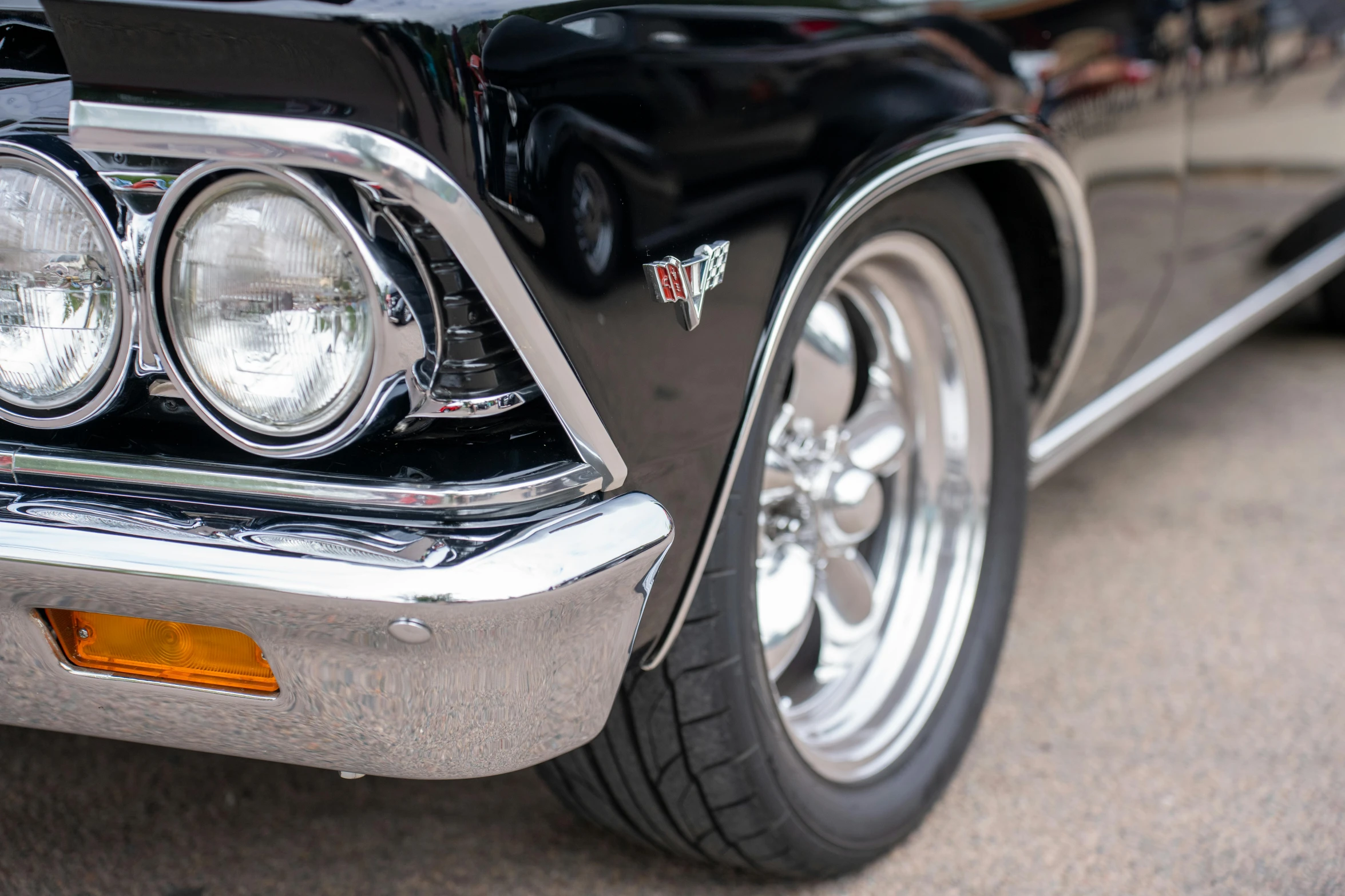 the taillight of a vintage car with chrome trim