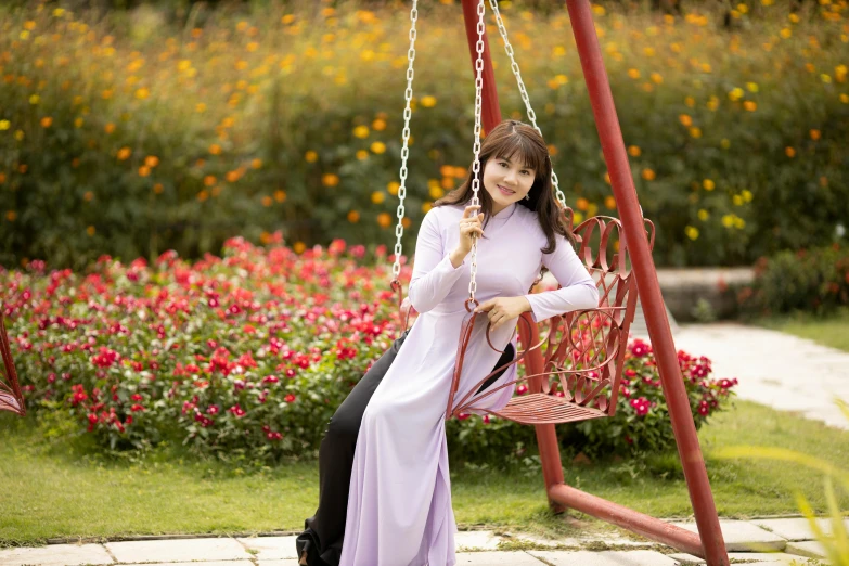  in white dress sitting on a swing