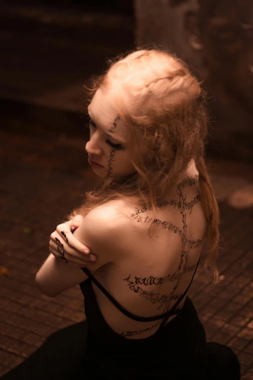 a young woman with very many different writing on her back