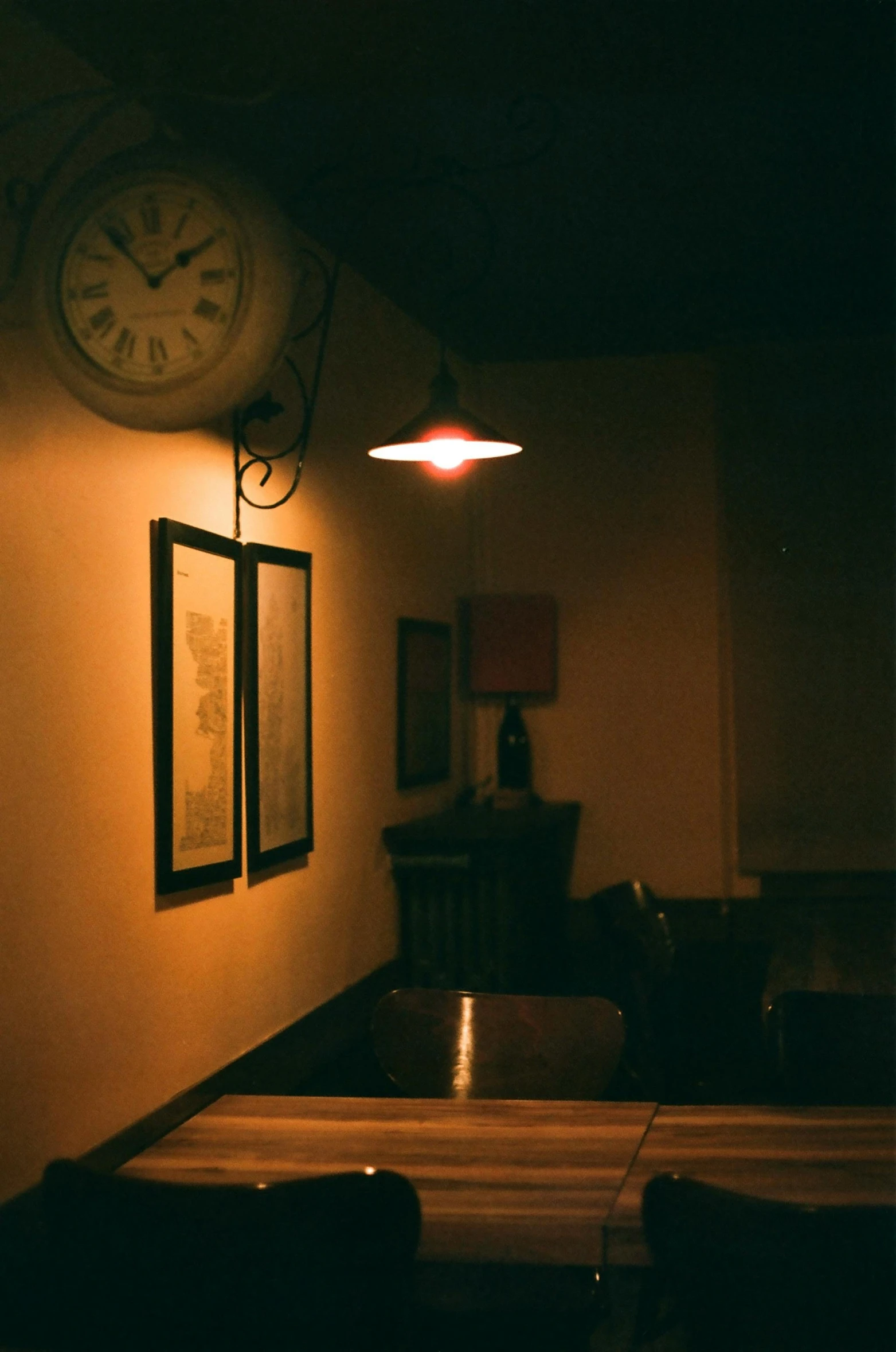 two clock faces at the end of a bar