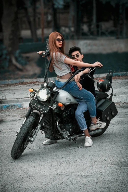 man and woman riding on motorcycle in parking lot