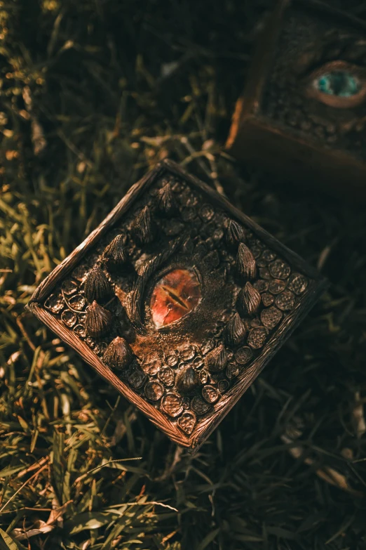 a square piece of an old wooden box with a small apple on top of it