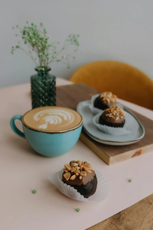 a plate with two coffees and some snacks on top of it