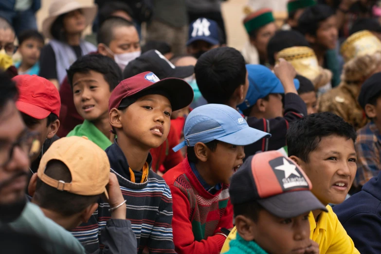 many children in front of a crowd at an event