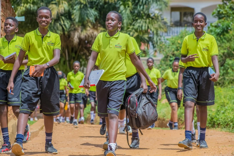 a group of girls running with tennis racquets