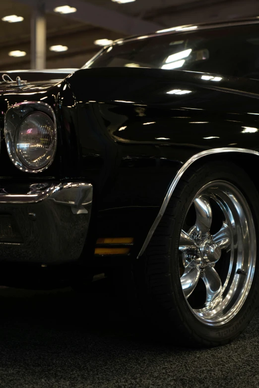 a vintage american car sits parked next to a building