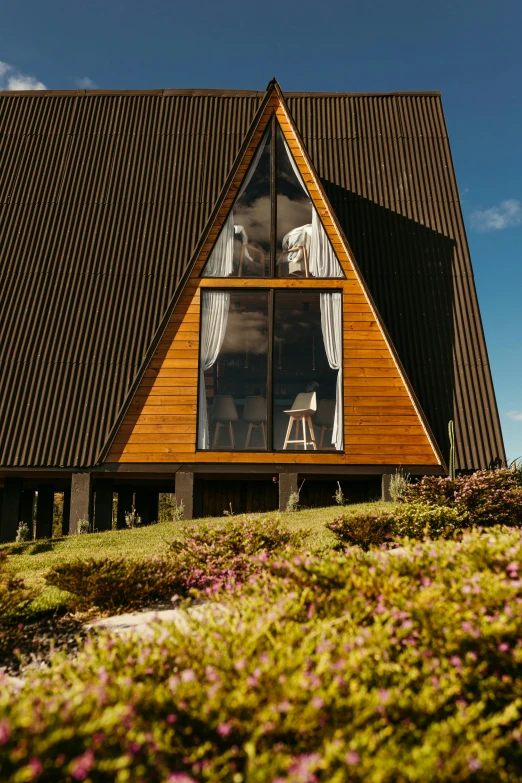 a wooden cabin with a sloping pitched roof