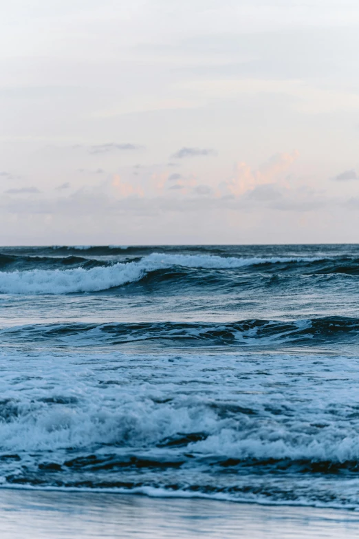 a lone surfer riding a wave into the ocean