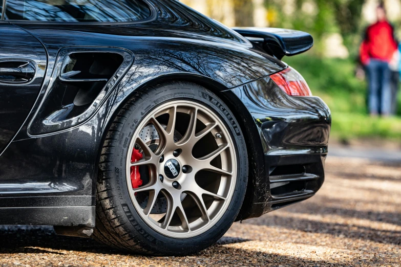 black sports car is parked with its wheel well