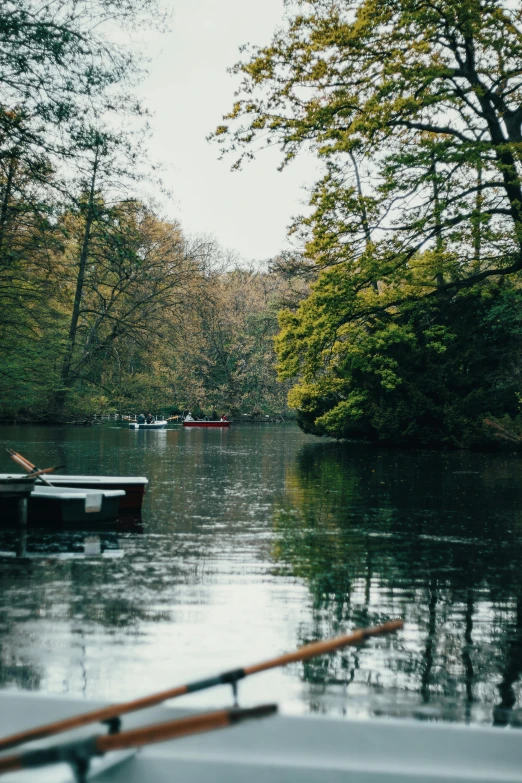 a river with boats and a fishing rod