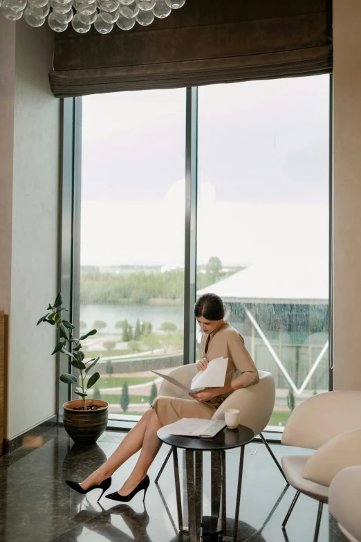 a woman sitting on a round chair in a room