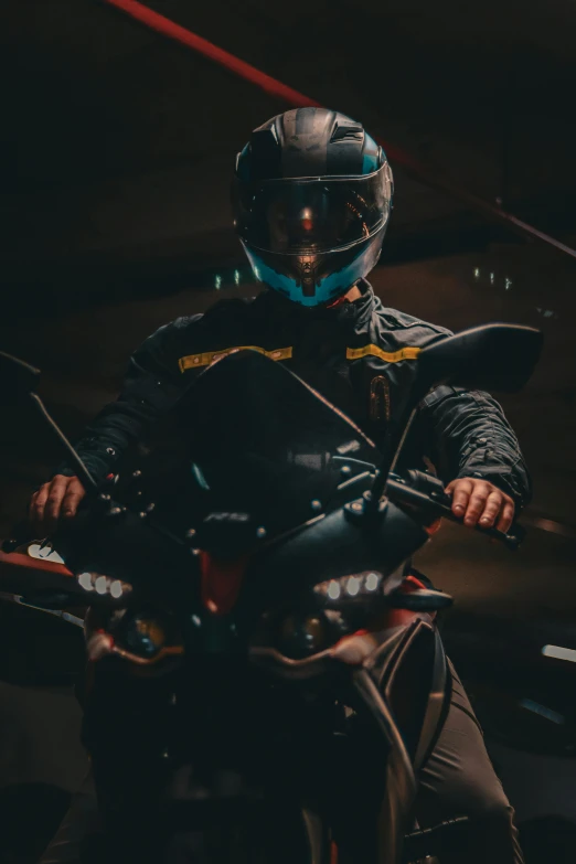 the motorcyclist is driving his motorcycle through a tunnel