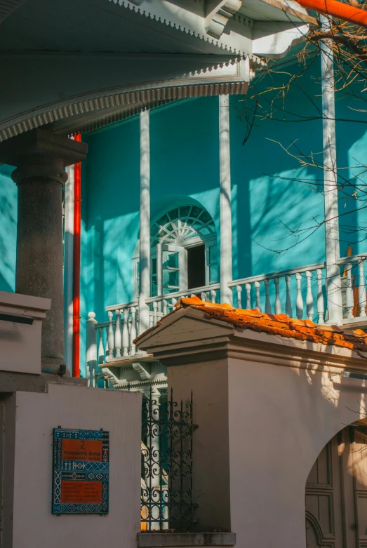 a small building that has a balcony and roof