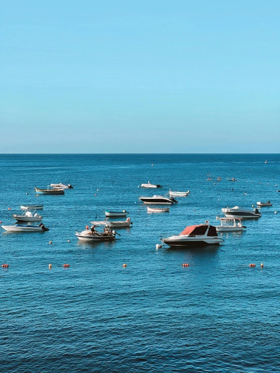 the boats are in the water outside together