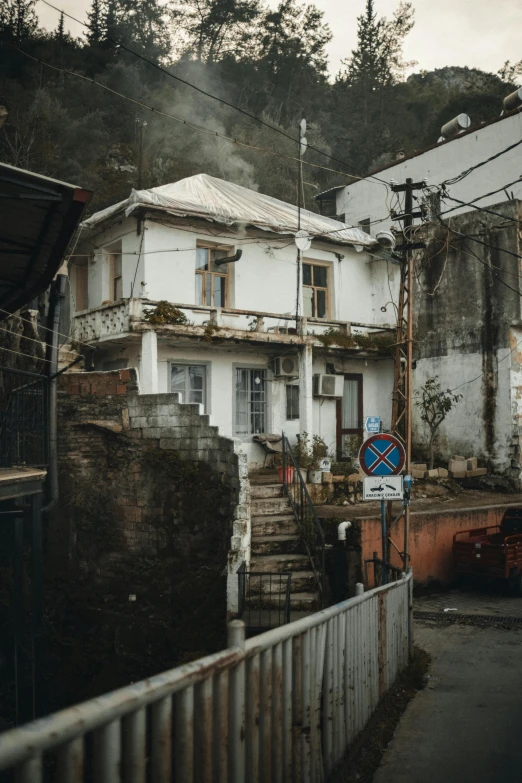 a city street with buildings, stairs, and trees