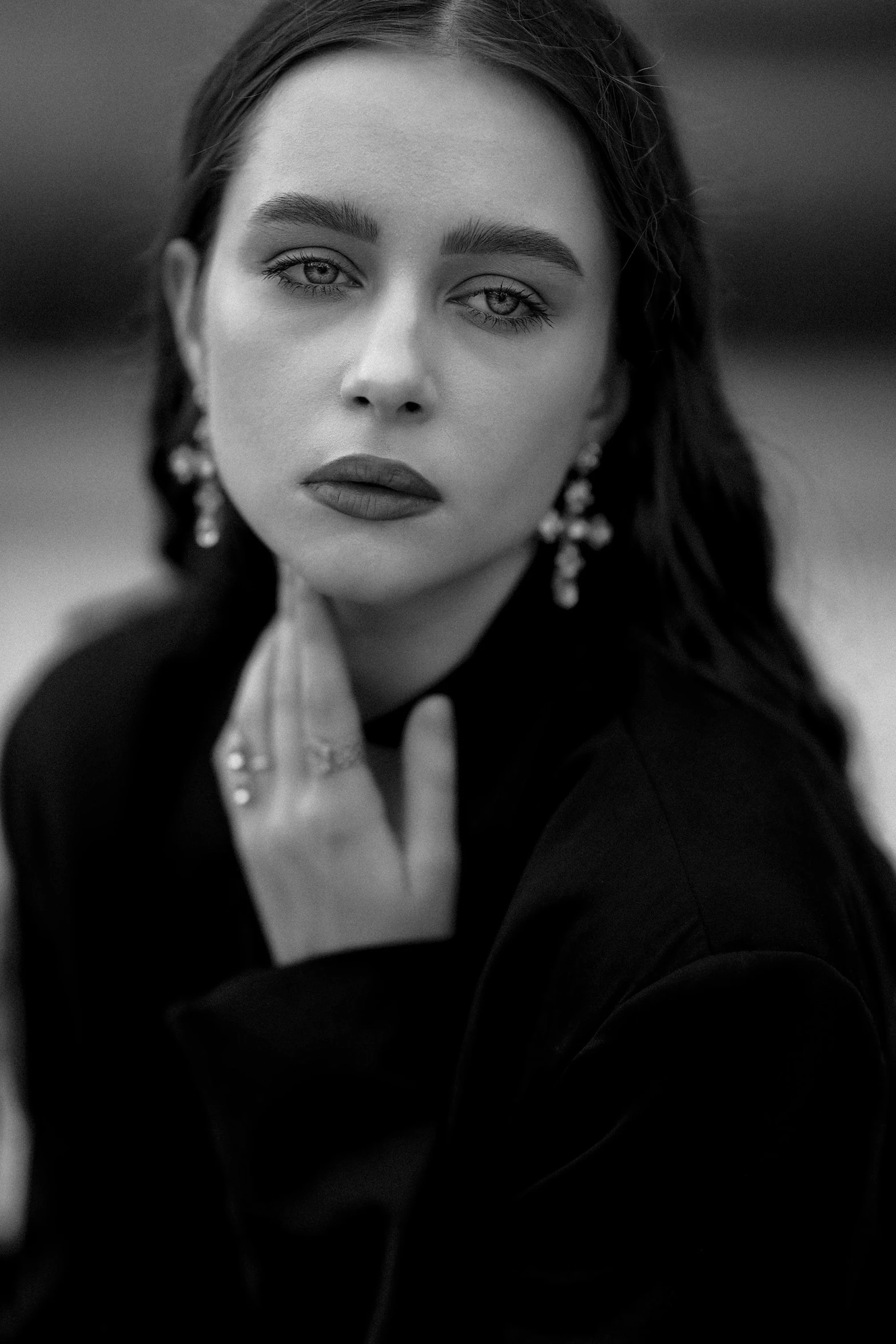 an attractive woman sitting in front of the camera