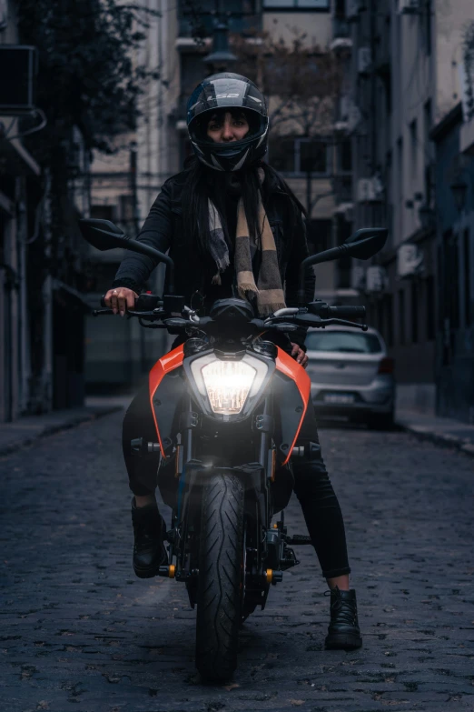 a man riding a motorcycle down a city street