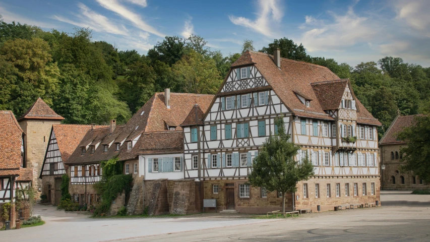 an old building with two storys is next to some trees