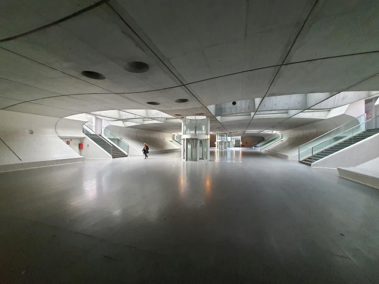 the inside of a building with stairs and escalators