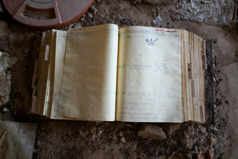 a book that has been opened sitting on some rubble