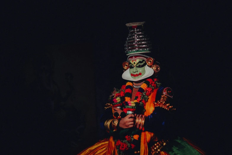 an idol made up of cloth, with red flowers