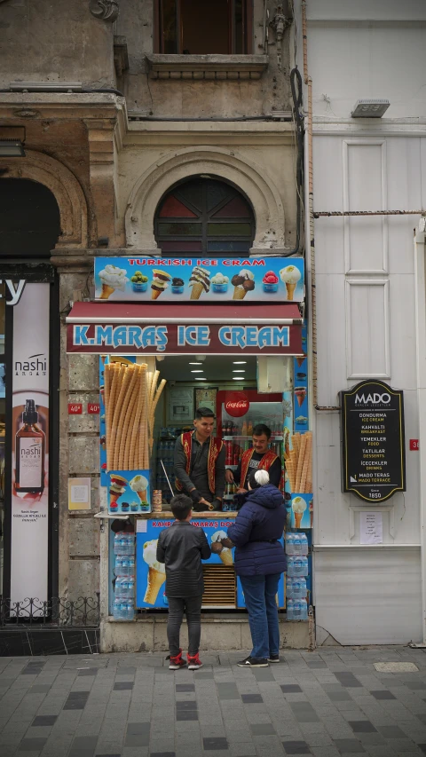 two people outside a food stand in a european city