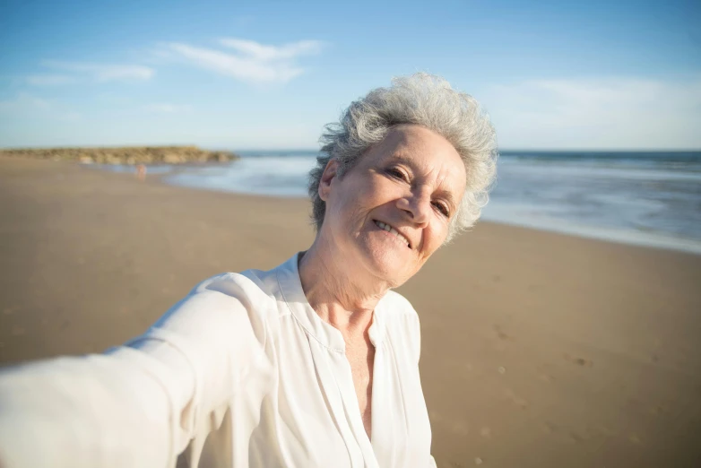 a close up of a person on a beach near the ocean