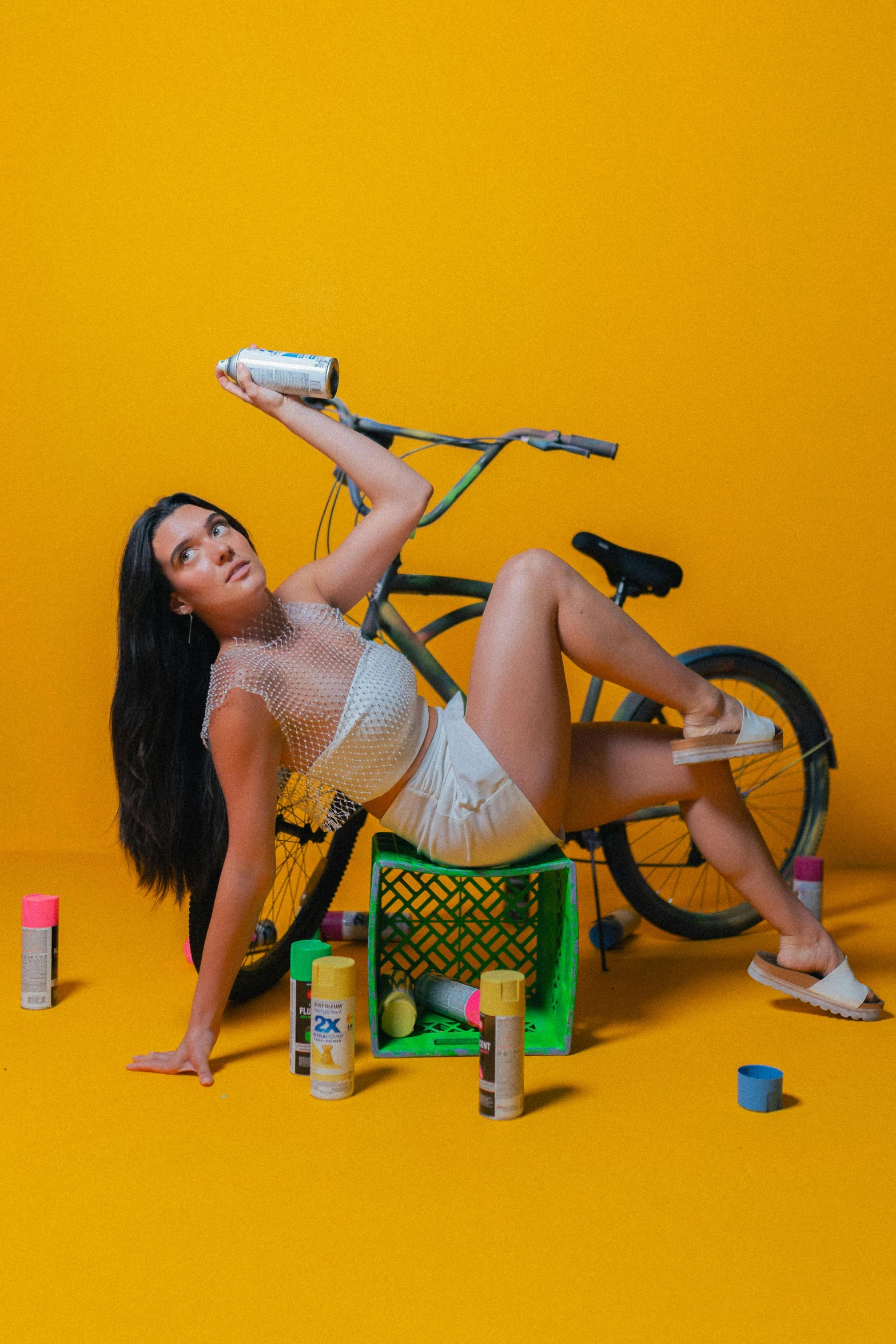 a woman in a white  and panties holding onto a bicycle