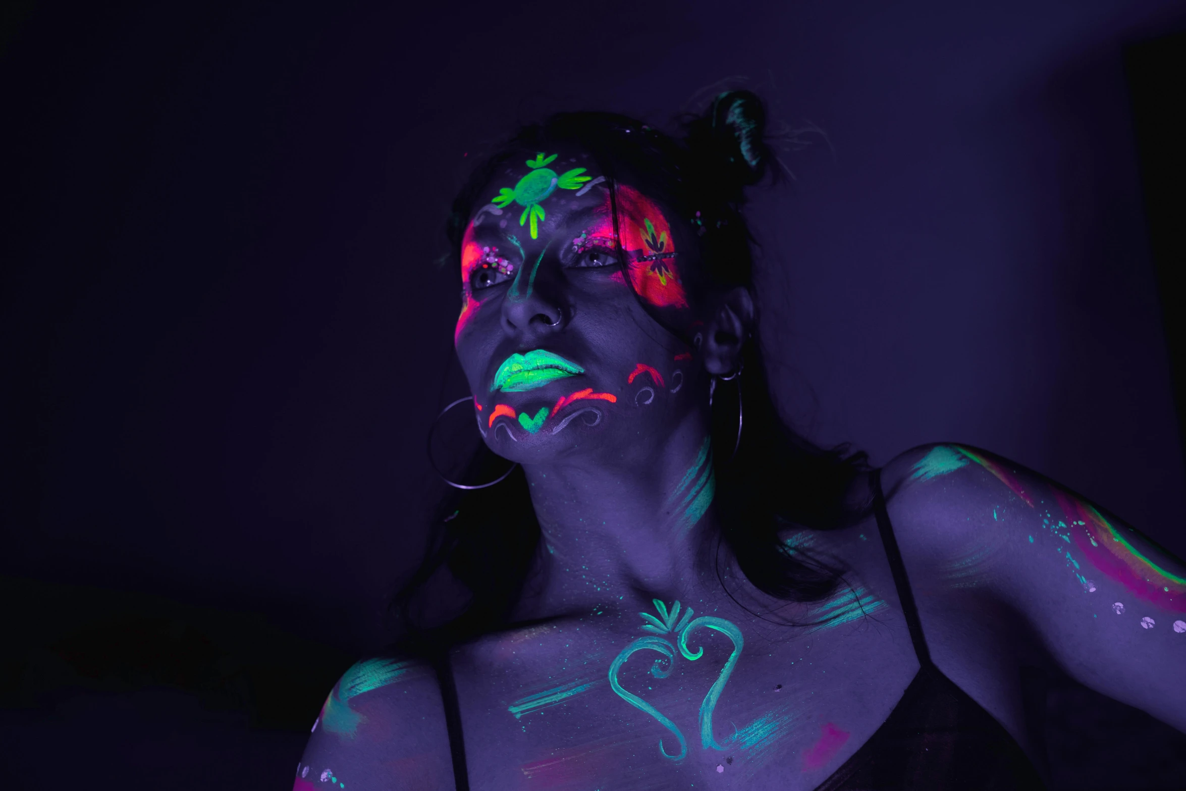 a young woman poses for the camera in fluorescent makeup