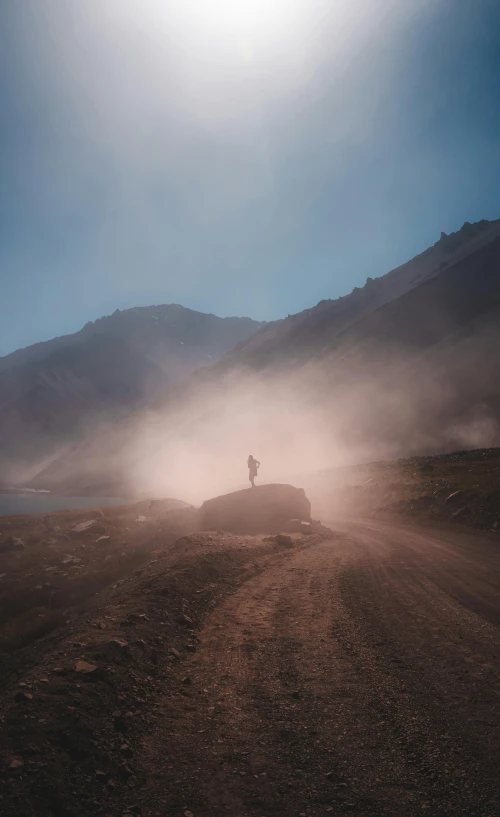 a person standing on a dirt road