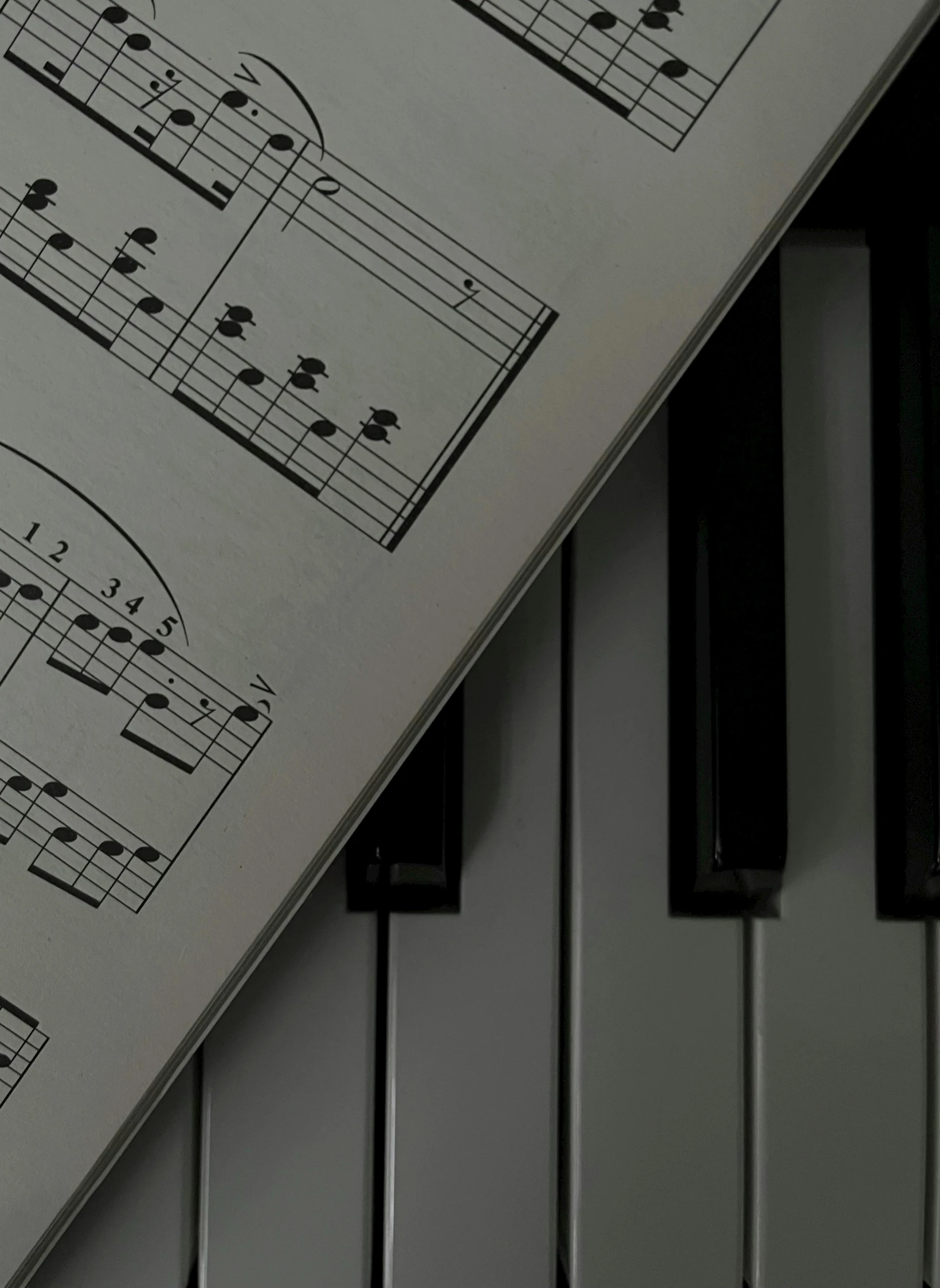 a sheet of music that has been placed near piano keys