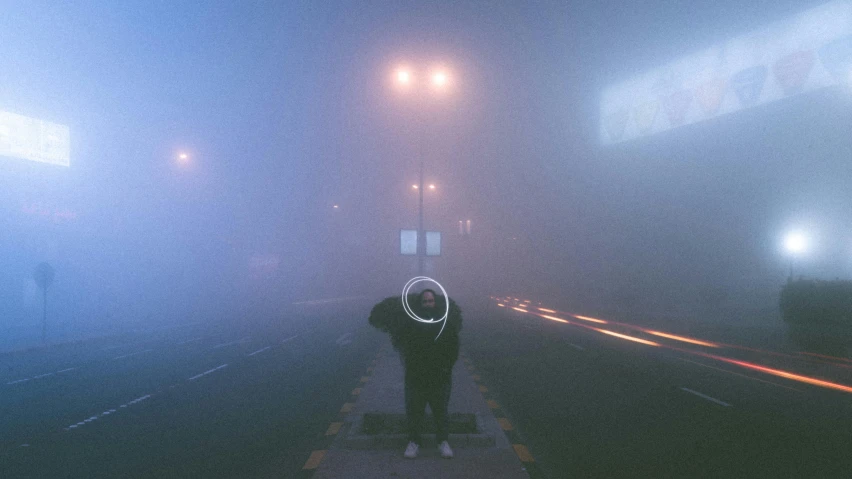 a person standing in front of a foggy city street