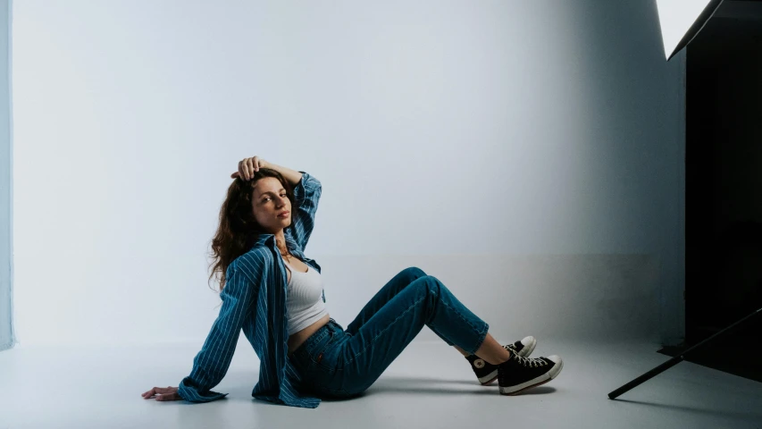 a beautiful young woman posing in front of a camera