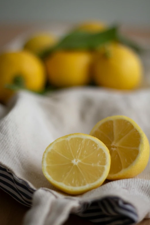 one yellow lemon is sliced and placed next to another