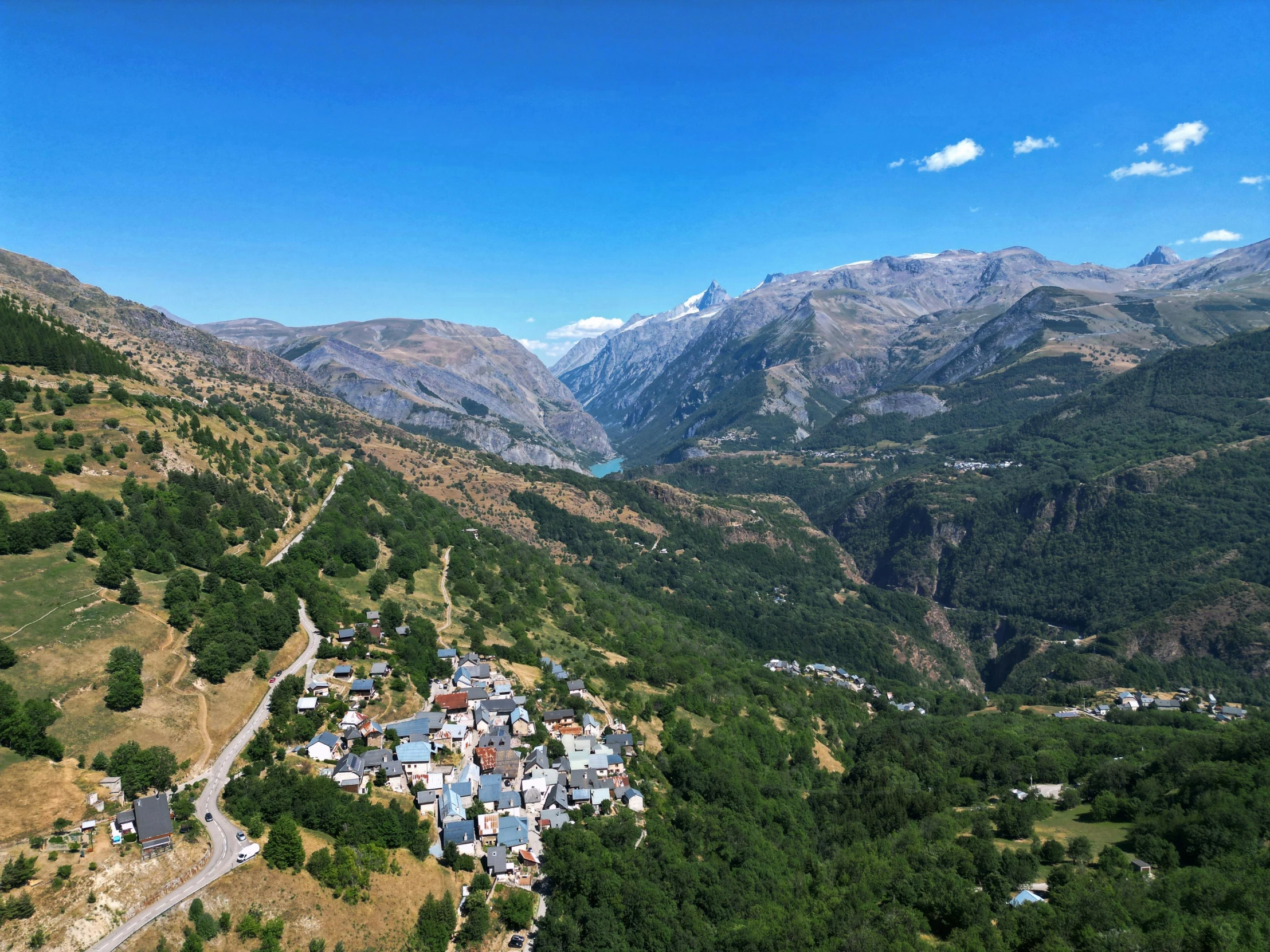 a view of a village nestled in the mountains