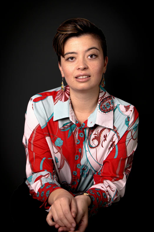 a woman posing for a po in her blouse