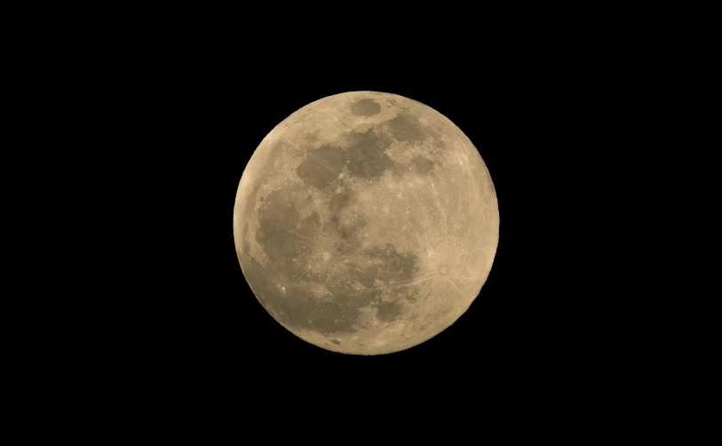 a full moon seen through the night sky