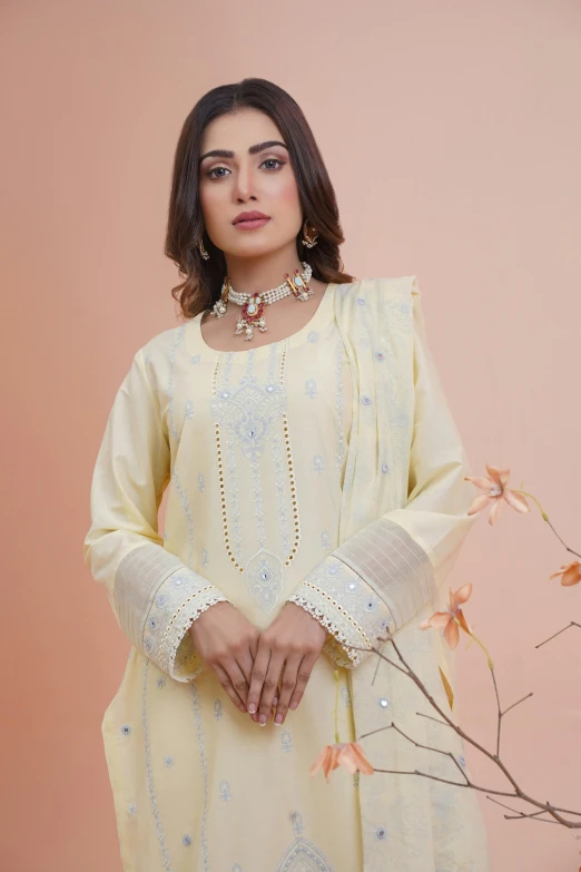 a woman posing for the camera while wearing a yellow ensemble