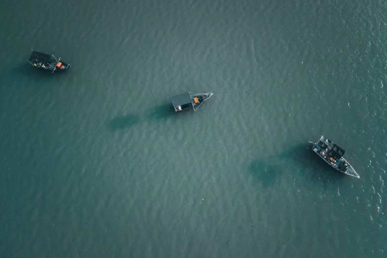 several boats that are in the water near each other