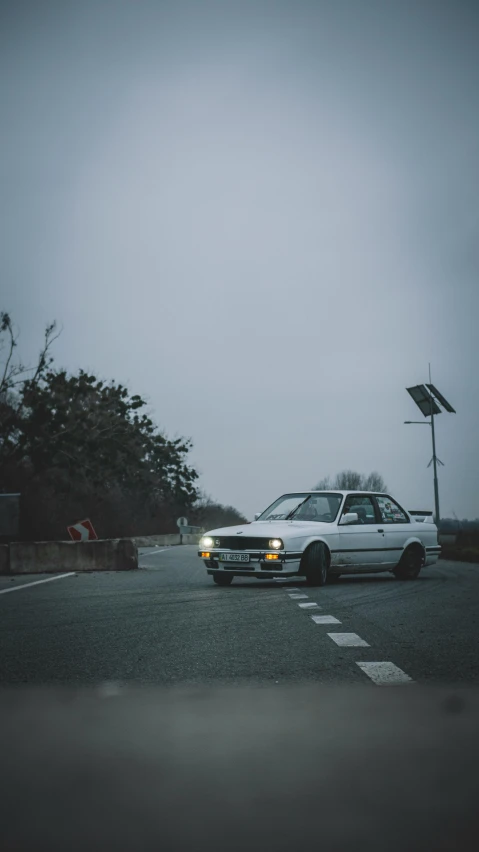 a car parked near an intersection in the rain