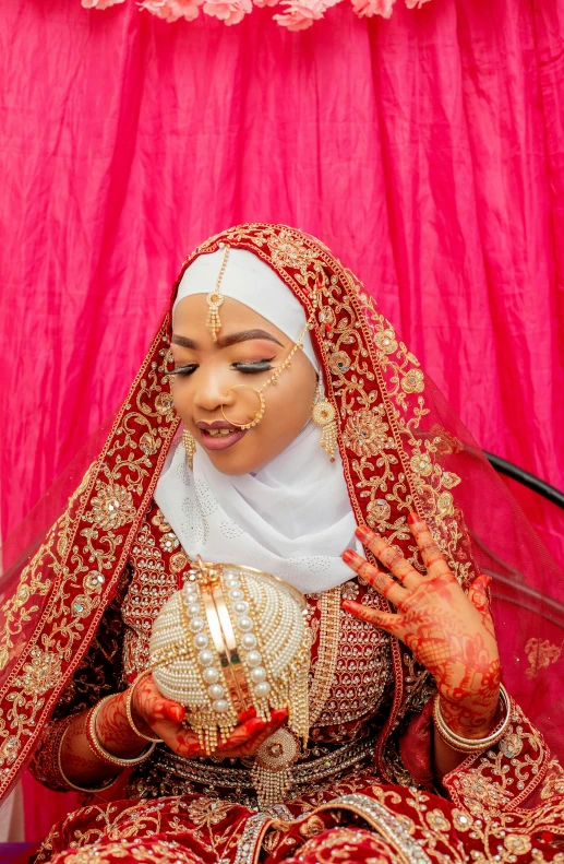 a woman in her bridal attire with a ring on her finger