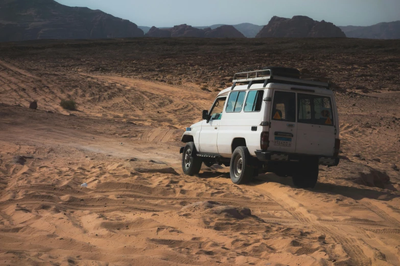 an automobile in the desert on the side of the road