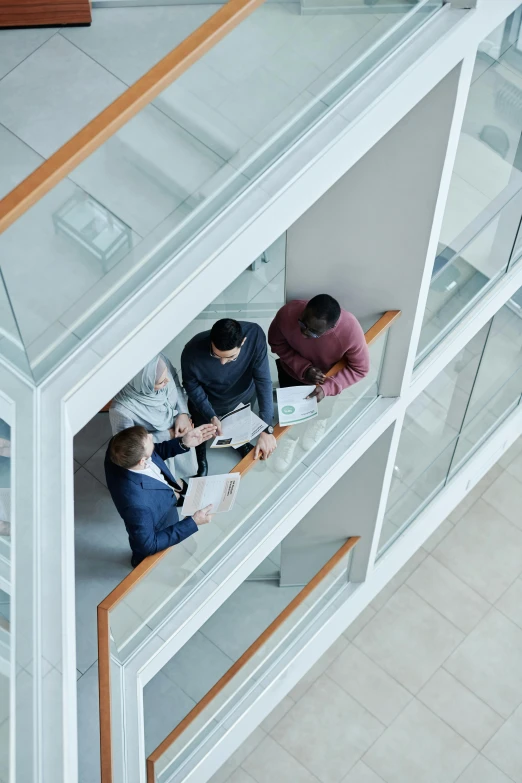 an aerial view of three business people at a meeting