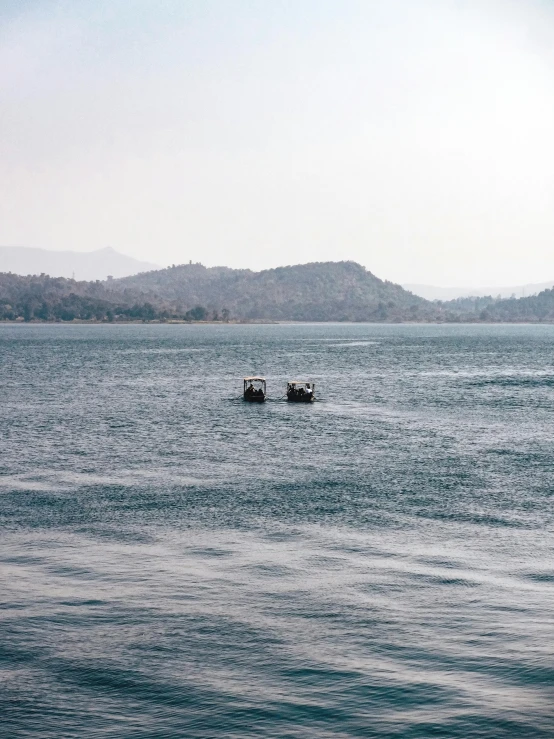 two people on small boats in the ocean