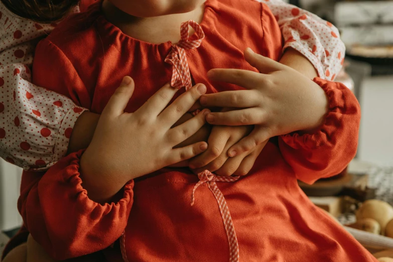 a girl holding a young doll in her arms