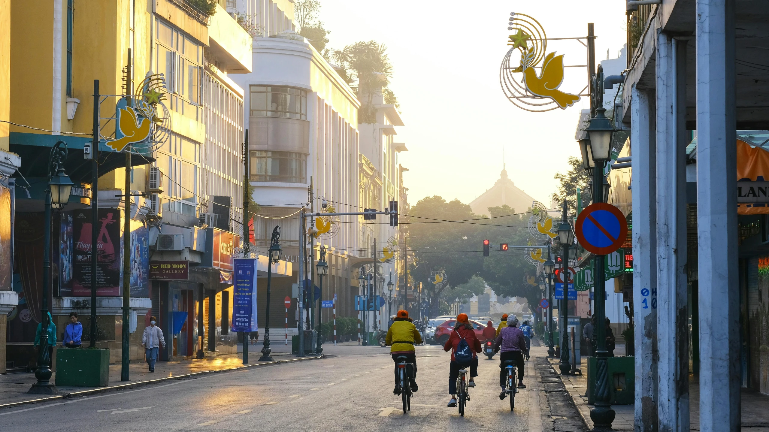 a couple people on bikes riding on a busy street