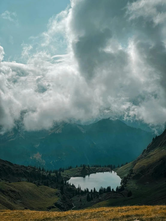 the mountains are covered with clouds and water