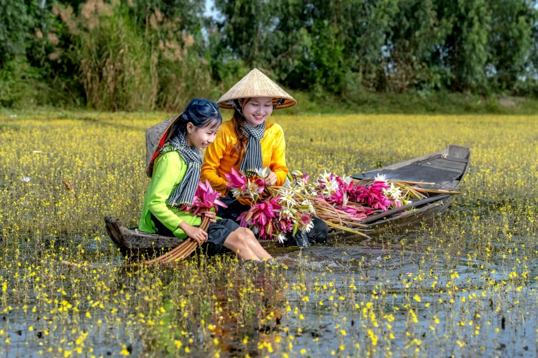 two woman are sitting in water on boats