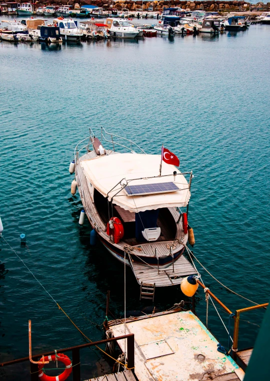 a boat docked at a marina with other boats